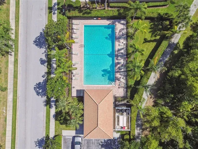 an aerial view of a house with a yard and potted plants