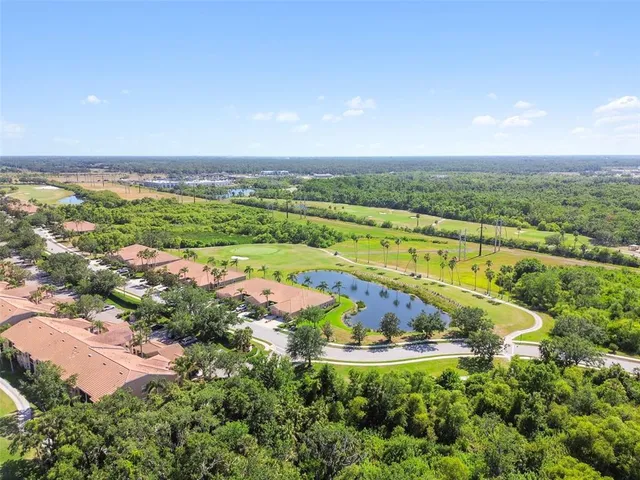 an aerial view of beach and residential houses with outdoor space