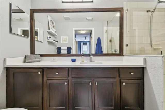 a bathroom with a double vanity sink and a mirror