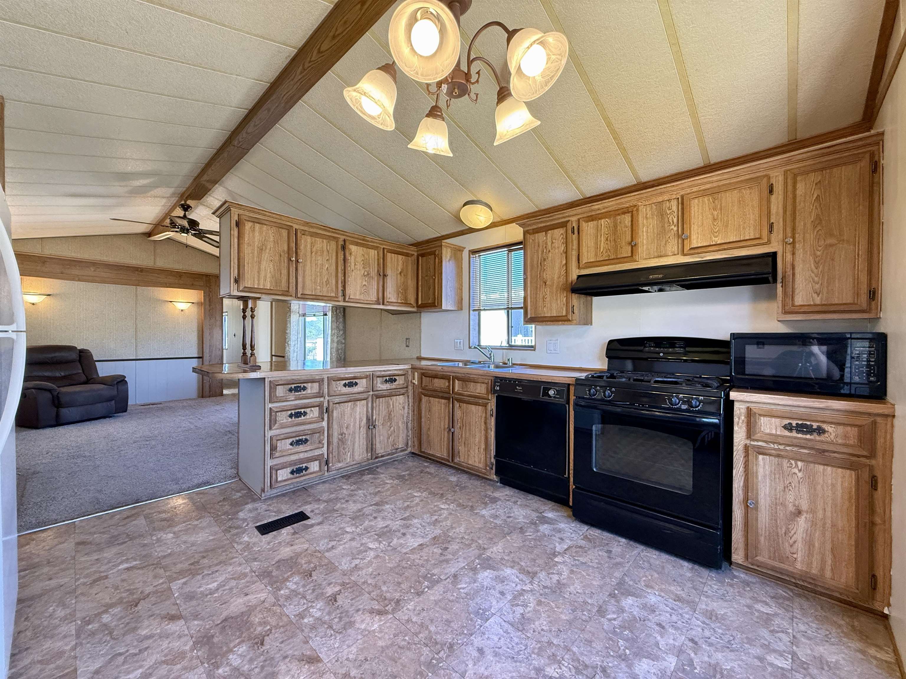 3251 E Road, Unit 33 Clifton, CO 81520 - Photo 7 of 28 a kitchen with stainless steel appliances granite countertop a stove sink and cabinets