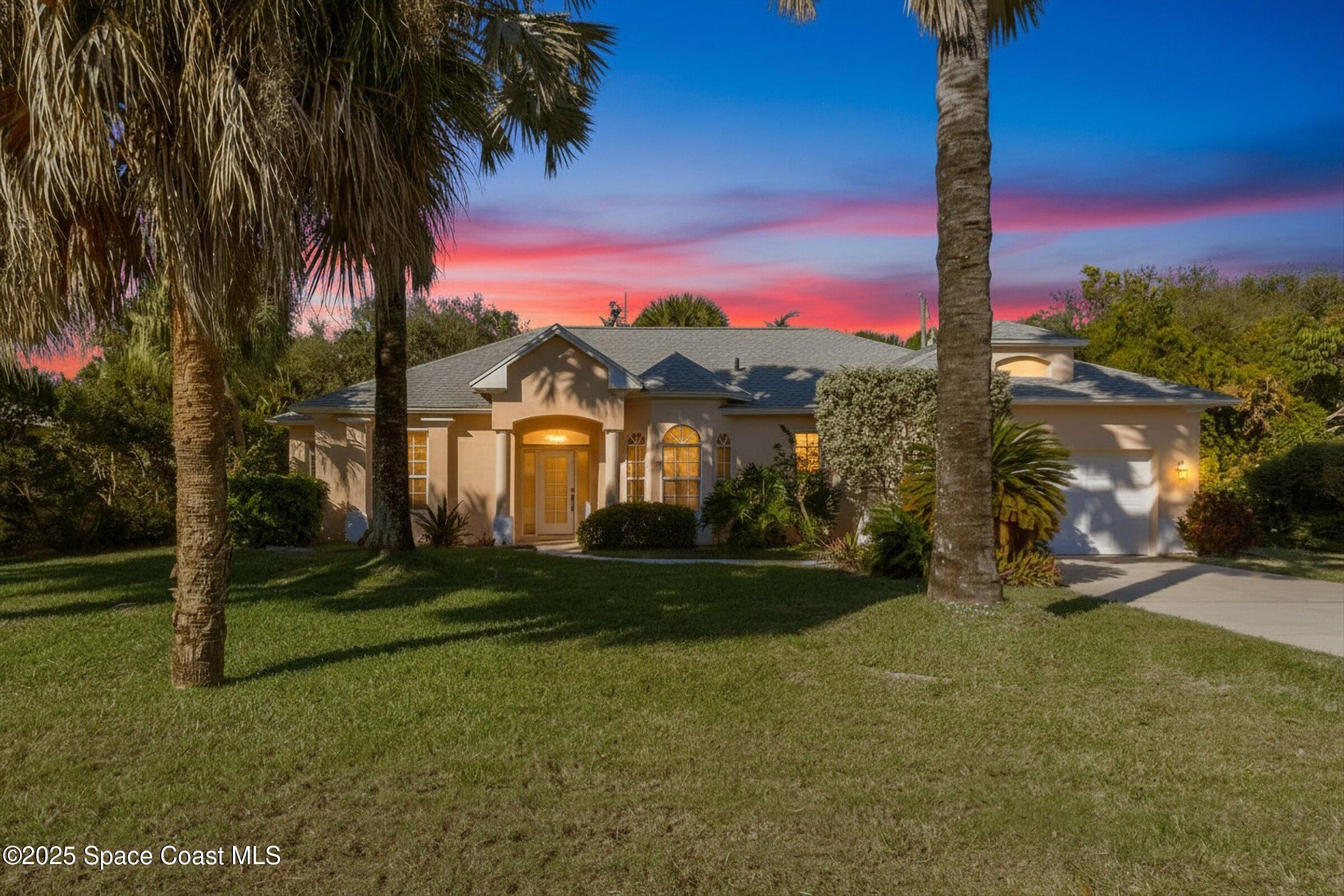 216 3rd Avenue Indialantic, FL 32903 - Photo 1 of 37 a view of a white house with a big yard and palm trees
