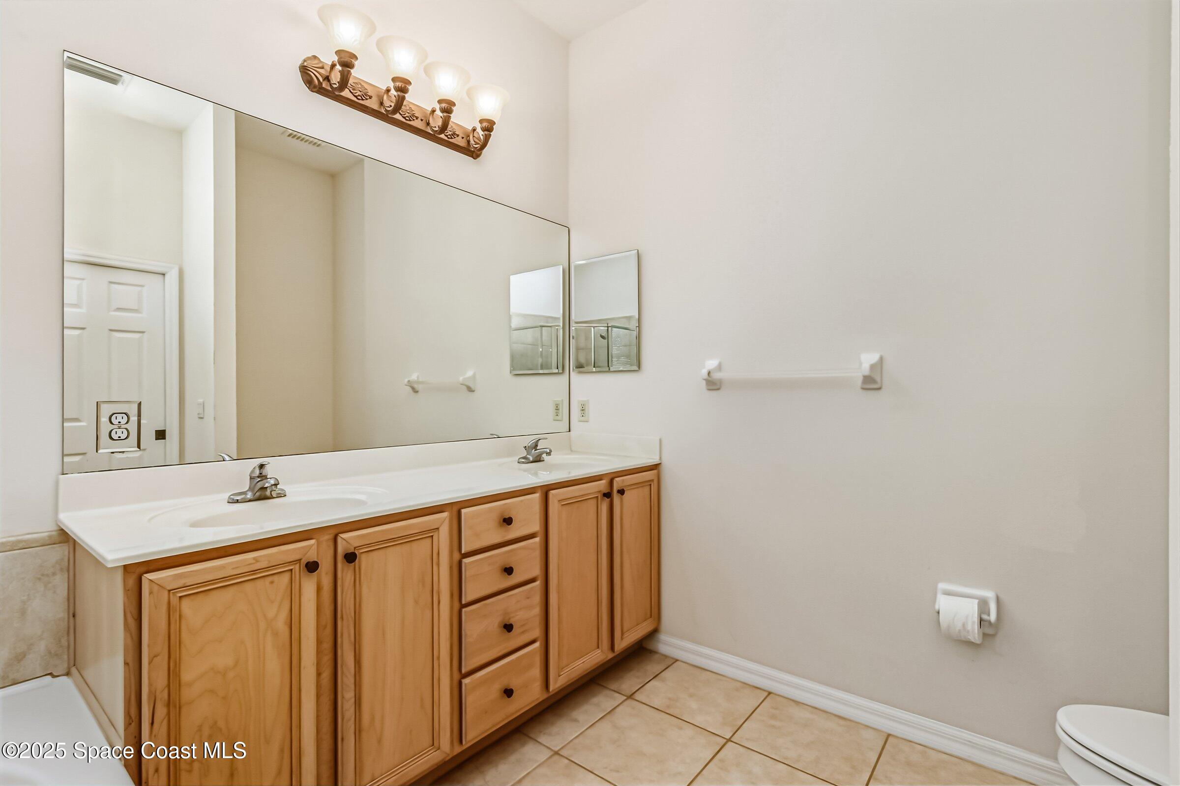 216 3rd Avenue Indialantic, FL 32903 - Photo 20 of 37 a bathroom with a sink a toilet and mirror