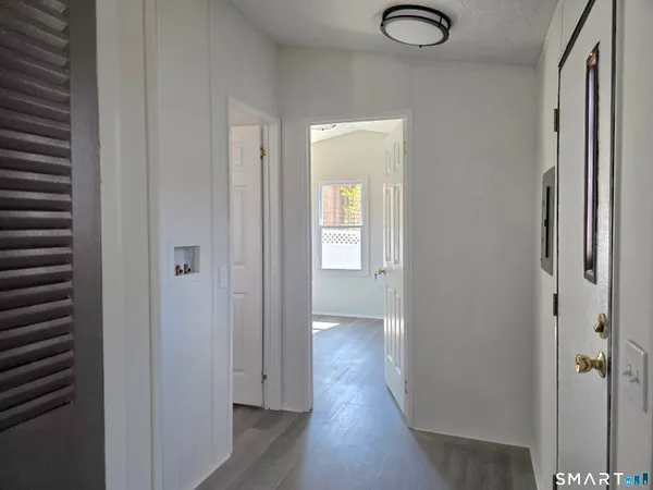 a view of hallway with wooden floor