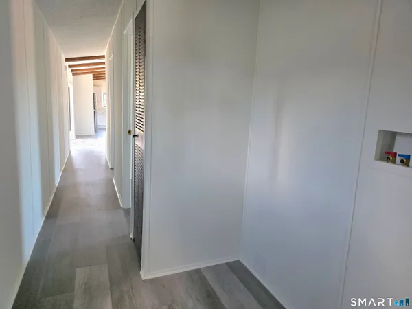 a view of a room with wooden floor
