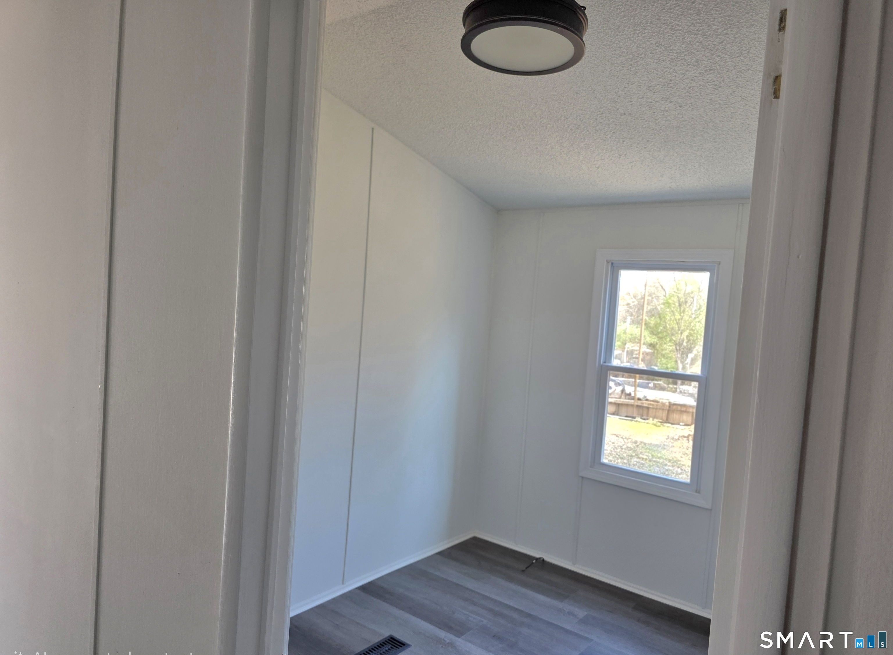 500 Washington Street, Unit 5 Middletown, CT 06457 - Photo 14 of 19 a view of empty room with wooden floor and fan