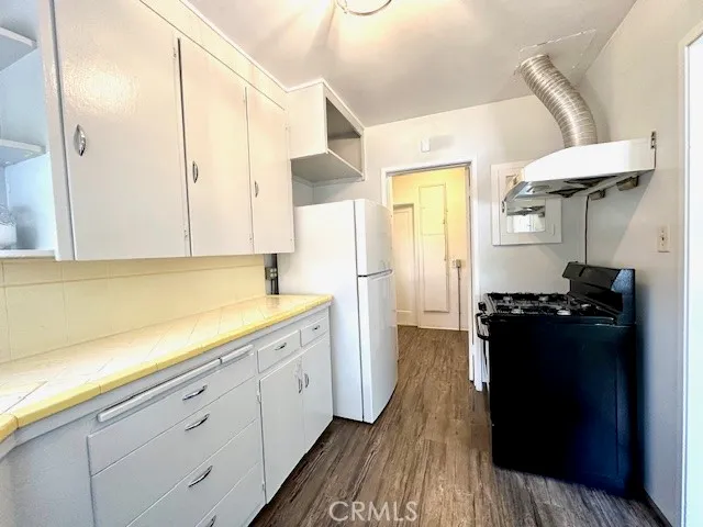 a kitchen with a refrigerator and a stove