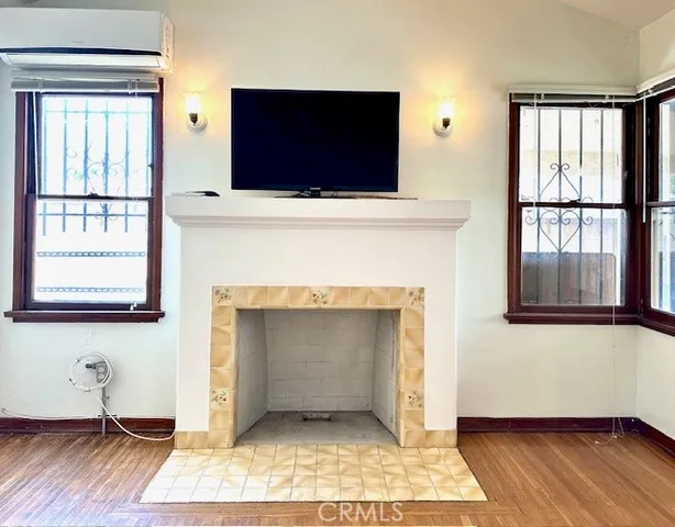 a living room with a fireplace and a flat screen tv