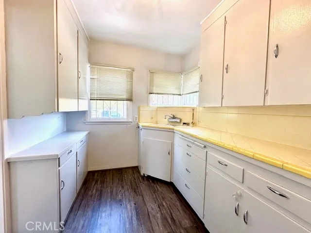 a kitchen with sink cabinets and wooden floor