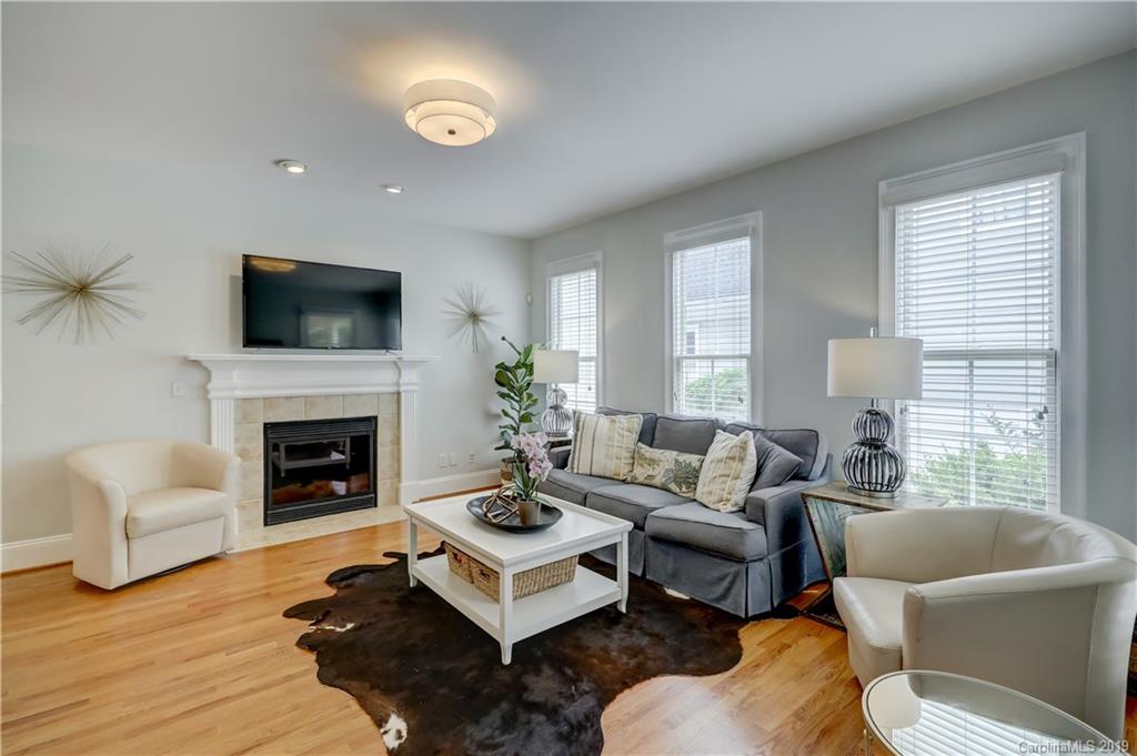 170 Mills Lane, Unit 761 Fort Mill, SC 29708 - Photo 12 of 35 a living room with furniture a fireplace and a flat screen tv