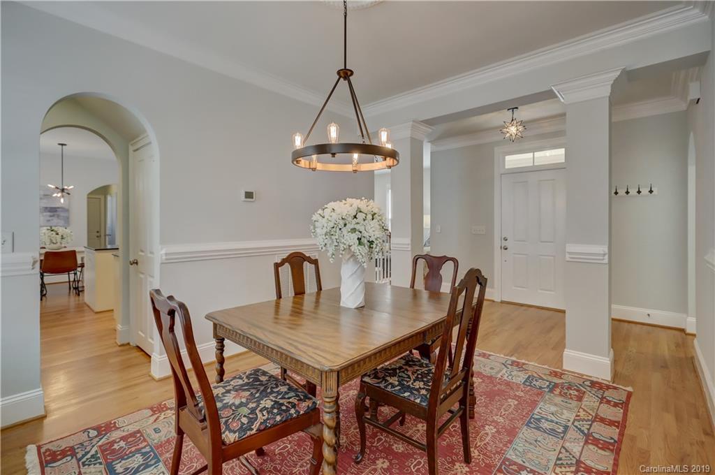 170 Mills Lane, Unit 761 Fort Mill, SC 29708 - Photo 7 of 35 a dining room with furniture a chandelier and wooden floor