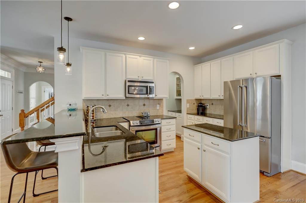 170 Mills Lane, Unit 761 Fort Mill, SC 29708 - Photo 10 of 35 a kitchen with stainless steel appliances granite countertop a refrigerator a stove a sink and a microwave