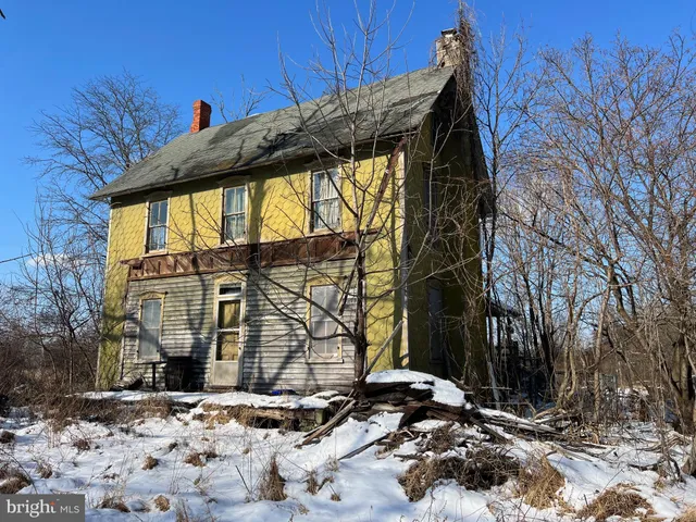 a view of a house with a snow on the road