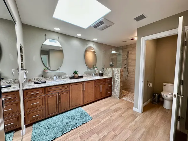 a spacious bathroom with a double vanity sink and a mirror