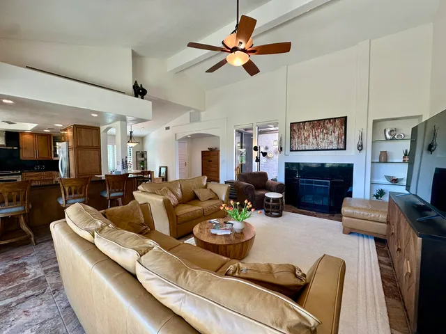 a living room with fireplace furniture and a fireplace