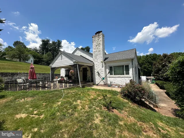 a front view of house with yard and outdoor seating