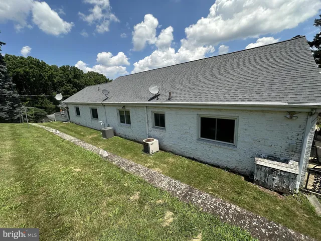a backyard of a house with table and chairs