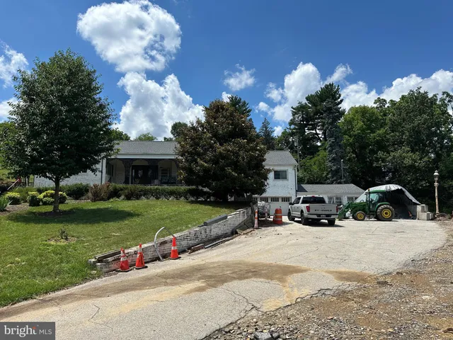 a view of a house with a garden and pathway
