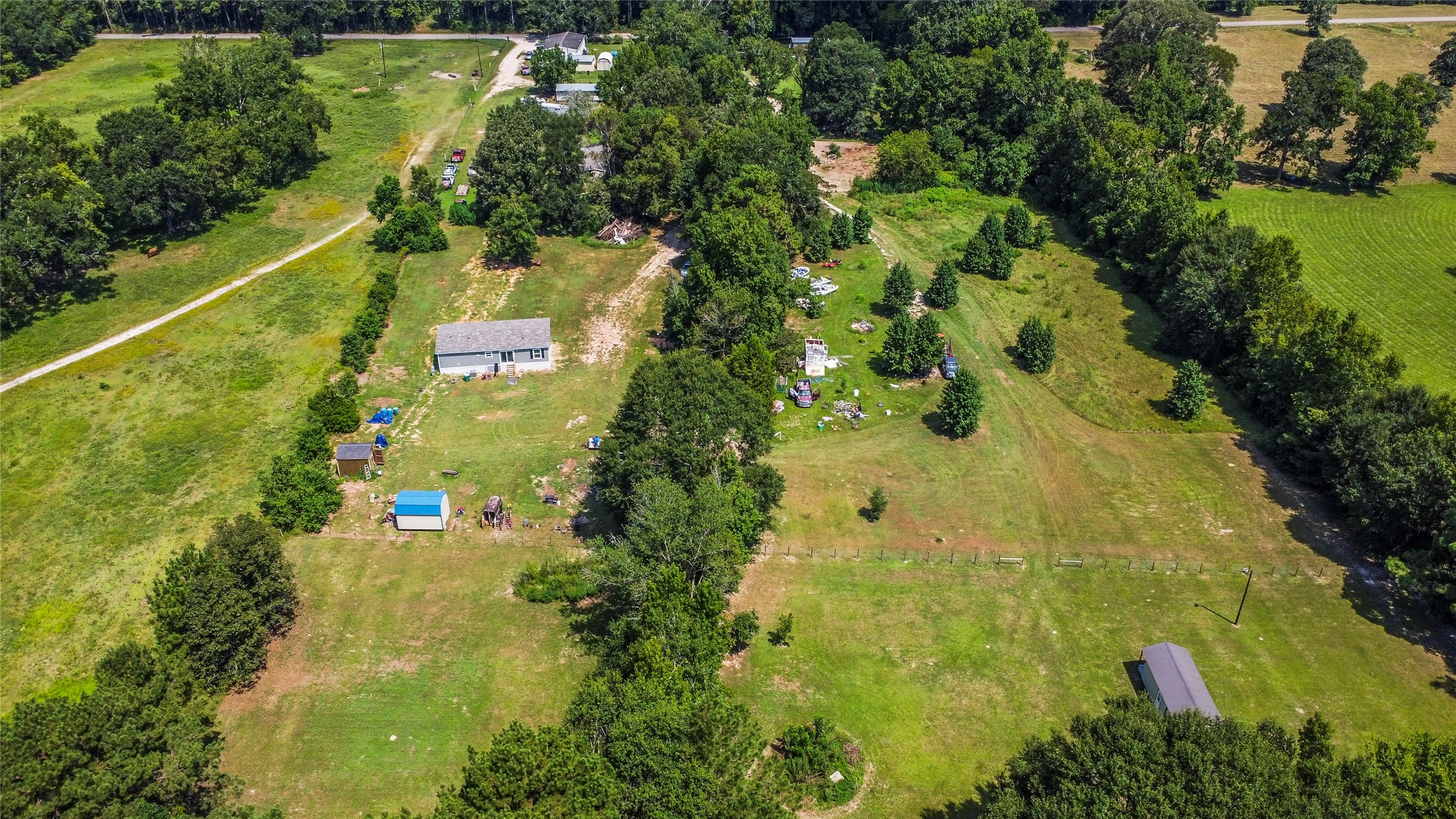 0 Stringtown Road Shepherd, TX 77371 - Photo 2 of 2 an aerial view of residential houses with outdoor space and trees all around