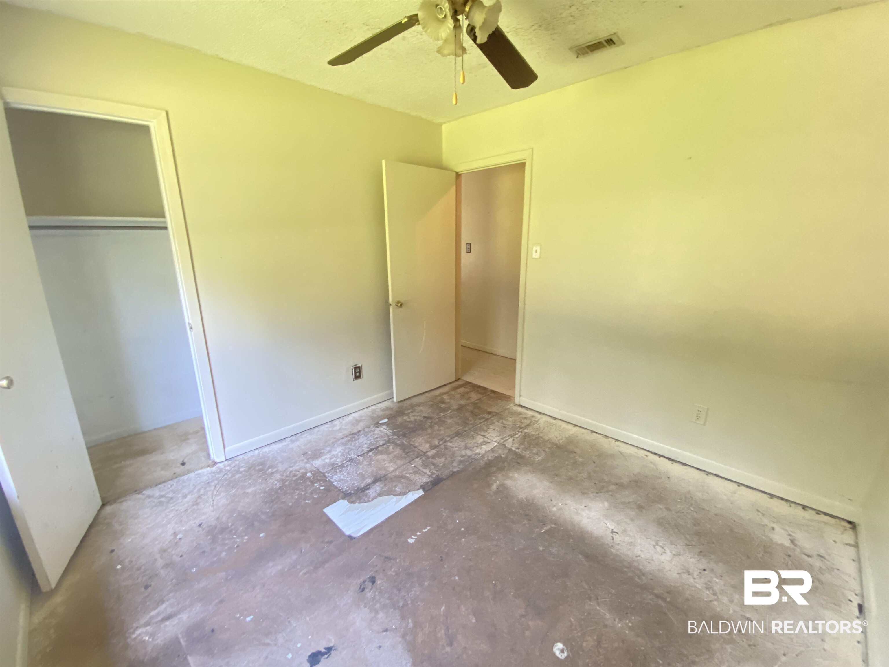 2616 Arc Road Mobile, AL 36605 - Photo 15 of 19 Unfurnished bedroom featuring a textured ceiling, ceiling fan, and a closet