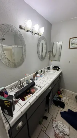 a room with a table chairs and appliances