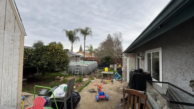 a view of a chairs and table in patio