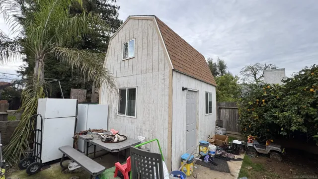 a view of outdoor kitchen and living room