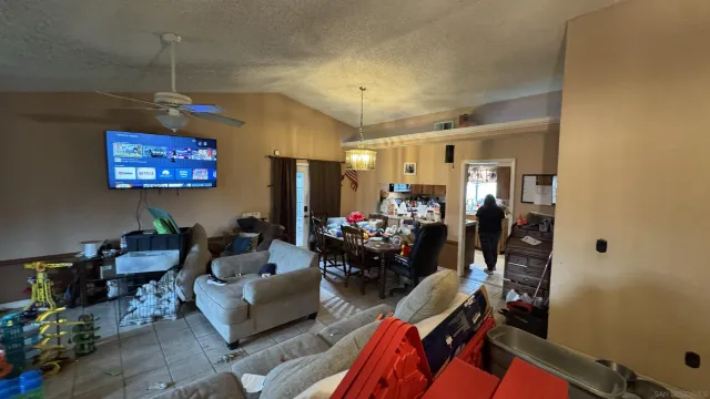 a living room with furniture and a chandelier