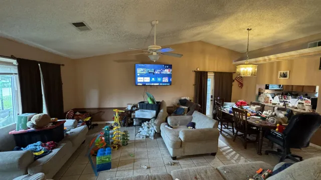 a living room with furniture a rug and a chandelier