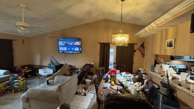 a living room with furniture a chandelier and a window