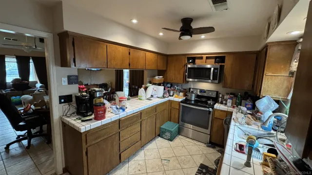 a kitchen with a sink appliances and cabinets
