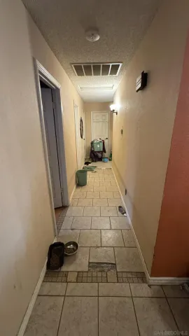 a view of a hallway and a livingroom with furniture