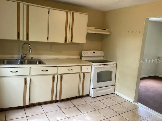 a utility room with sink dryer and washer
