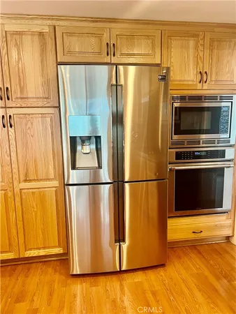 a metallic refrigerator freezer sitting in a kitchen