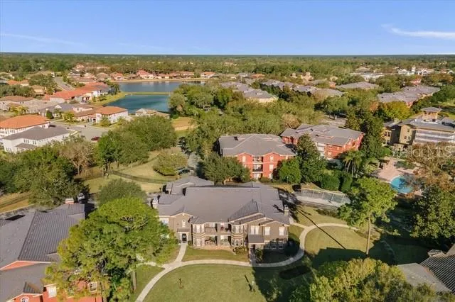 an aerial view of residential houses with outdoor space and river