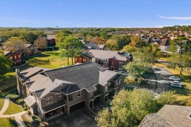an aerial view of residential houses with outdoor space