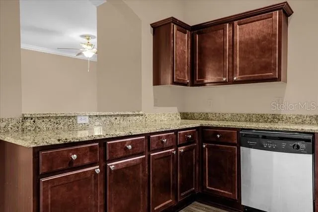 a kitchen with granite countertop a sink and cabinets