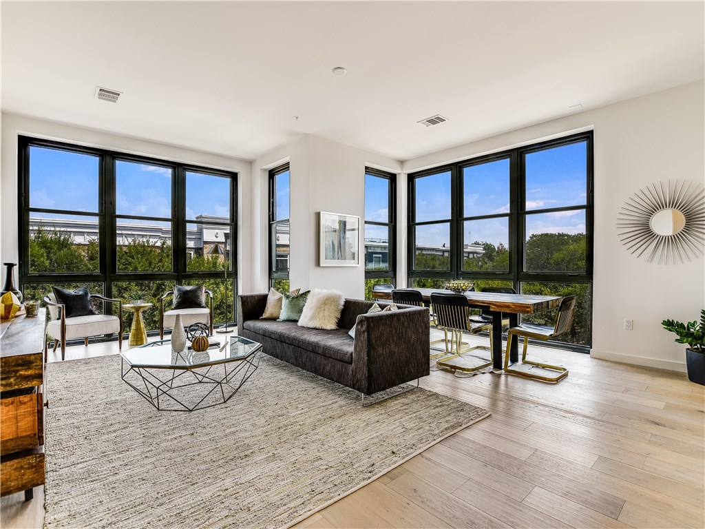 800 Embassy Drive, Unit 308 Austin, TX 78702 - Photo 1 of 1 a living room with furniture and a large window
