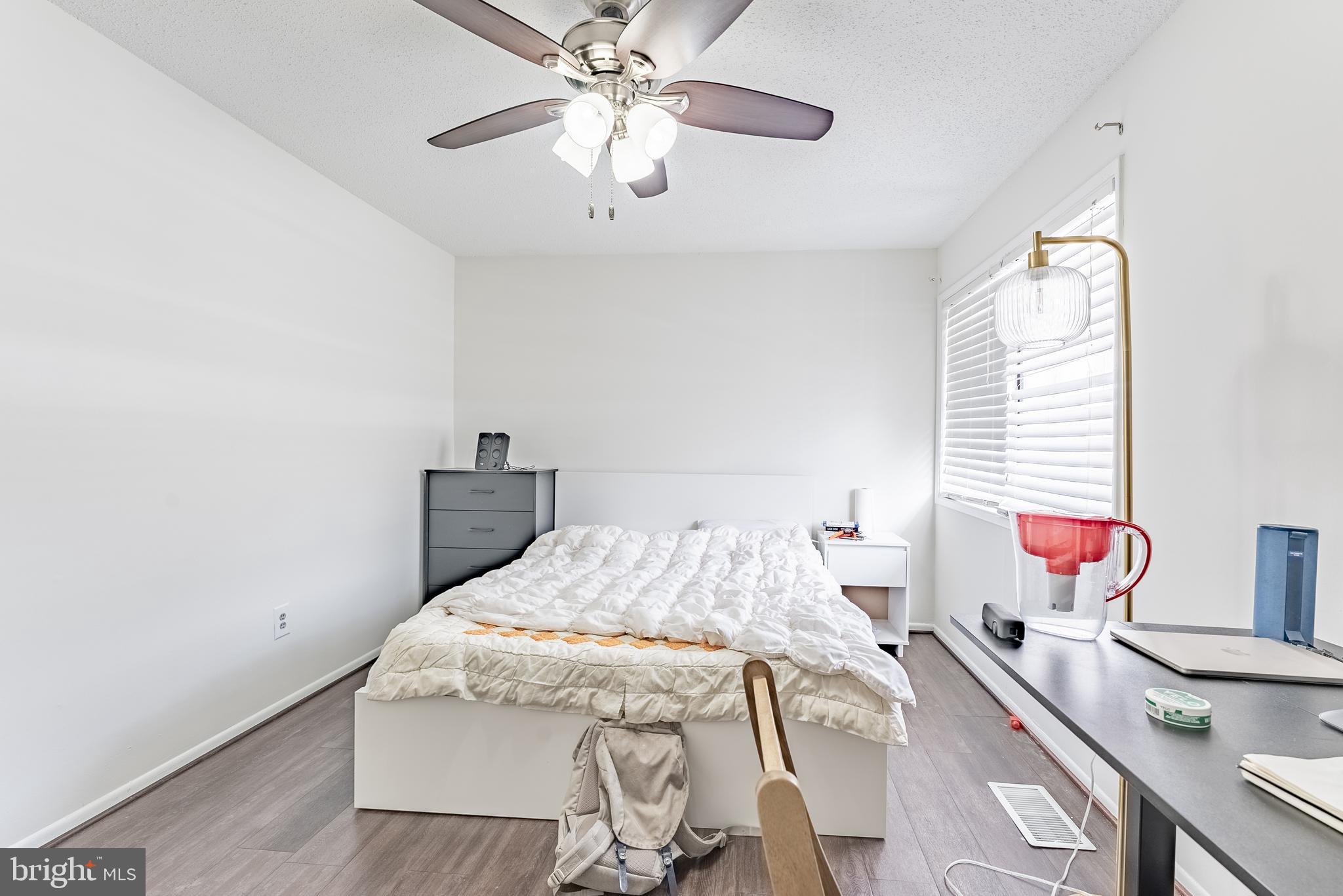 2412 Southgate Square Reston, VA 20191 - Photo 14 of 23 a bedroom with a bed and a chandelier