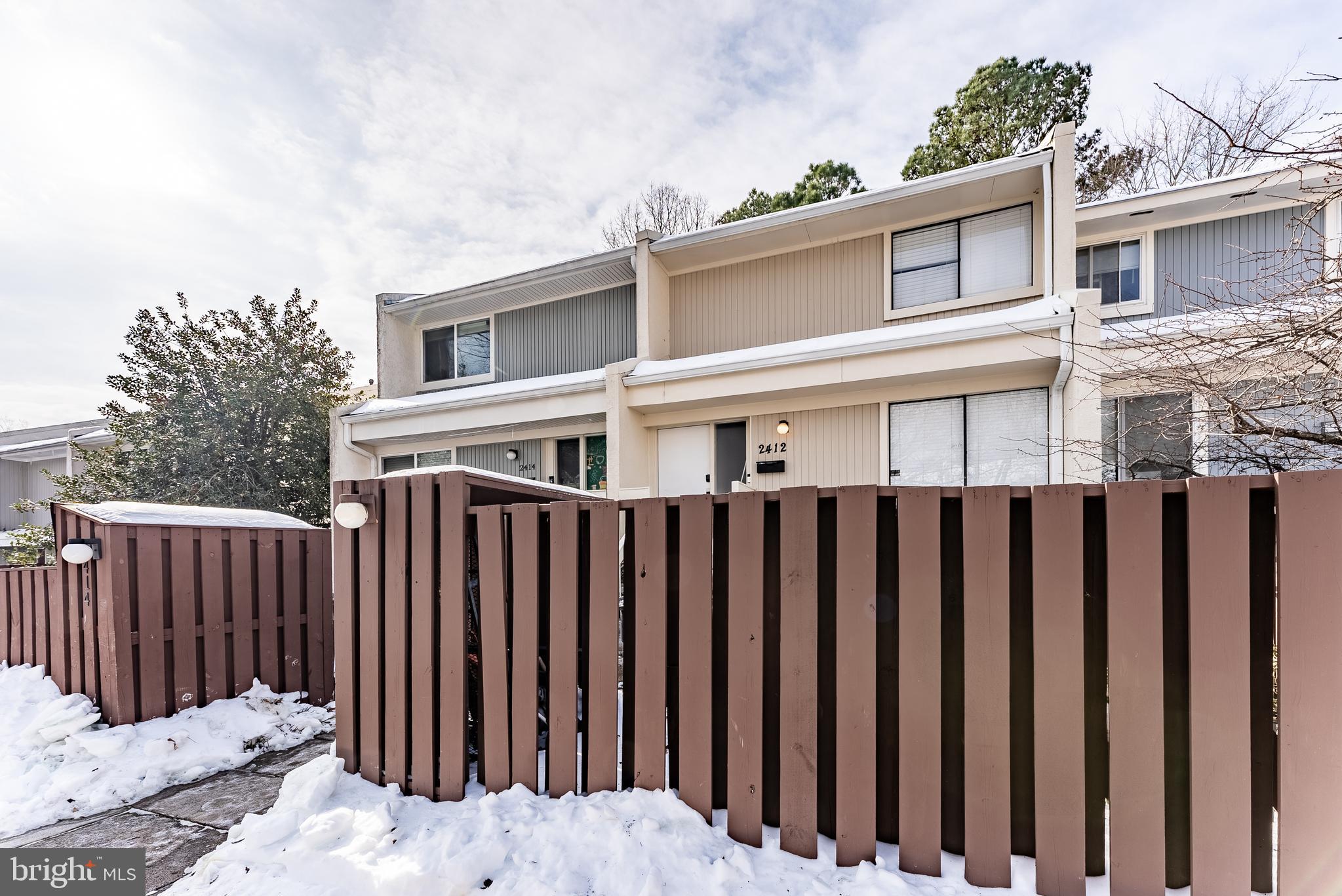 2412 Southgate Square Reston, VA 20191 - Photo 2 of 23 a front view of a house with a fence