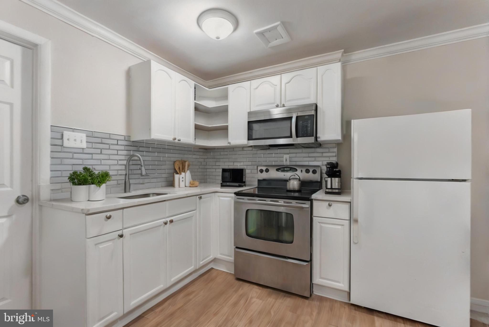 2412 Southgate Square Reston, VA 20191 - Photo 9 of 23 a kitchen with appliances a sink and cabinets
