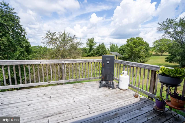 a view of deck with furniture and trees