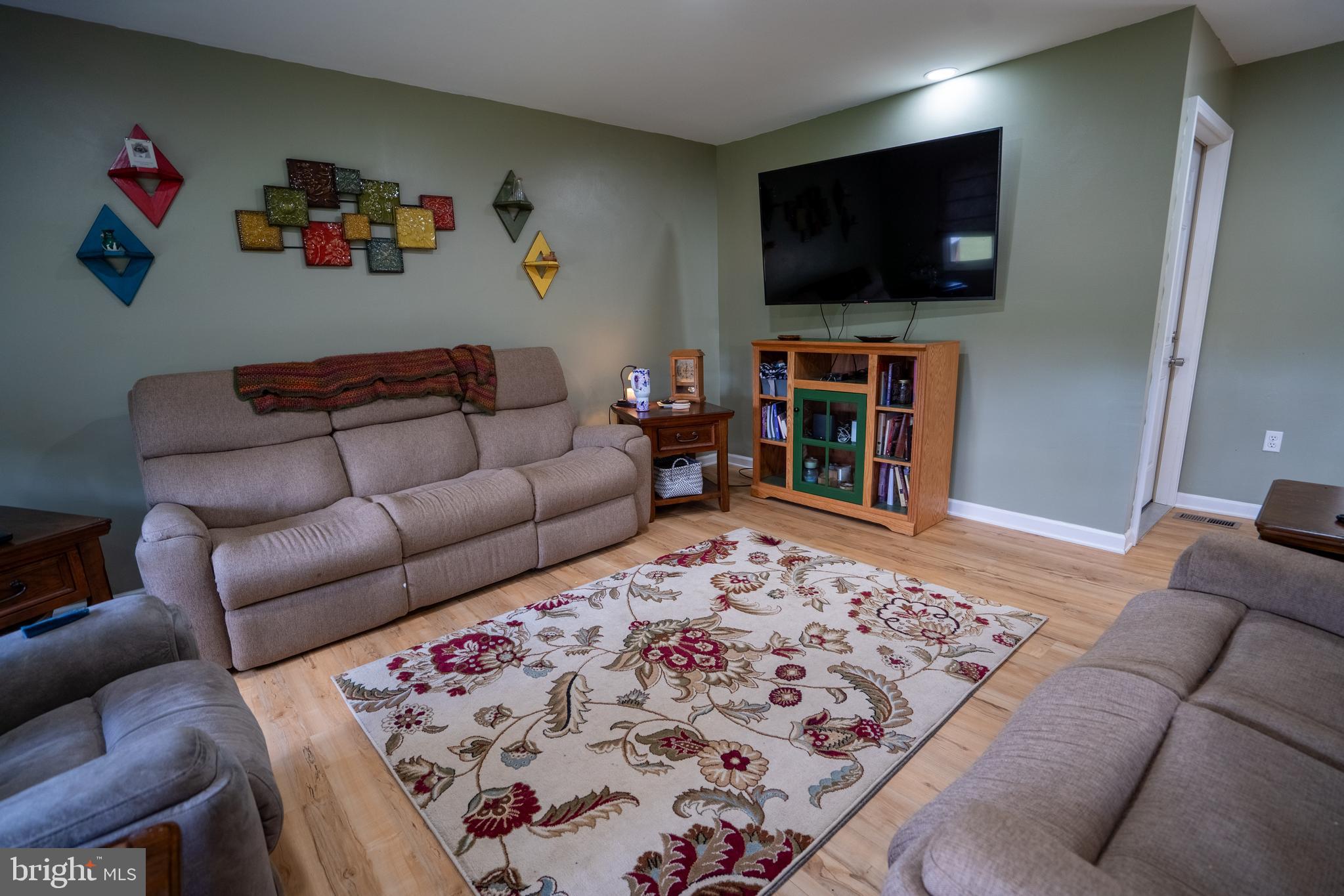 474 Potter Road Hedgesville, WV 25427 - Photo 17 of 40 a living room with furniture and a flat screen tv