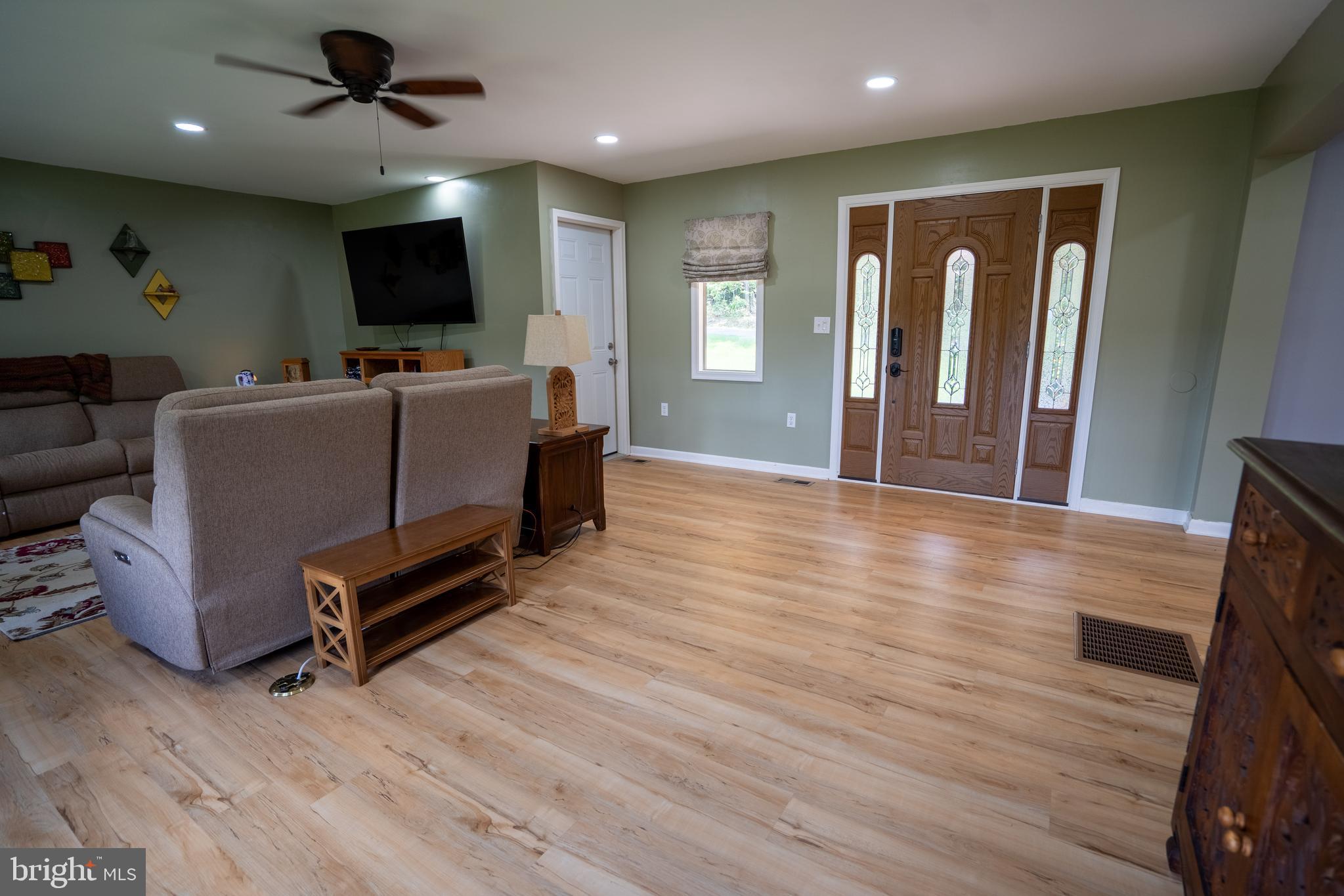 474 Potter Road Hedgesville, WV 25427 - Photo 18 of 40 a living room with furniture and a flat screen tv
