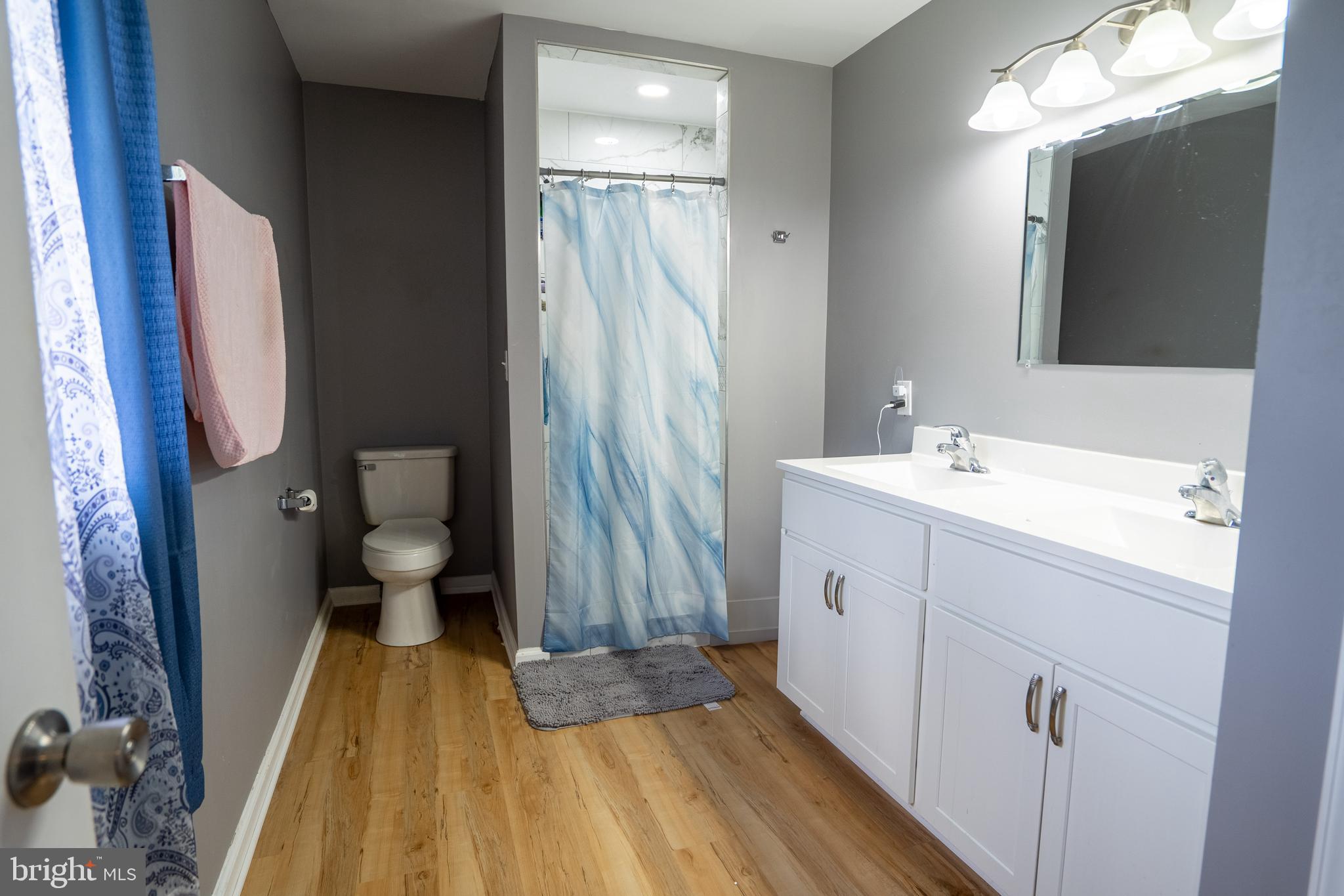 474 Potter Road Hedgesville, WV 25427 - Photo 21 of 40 a spacious bathroom with a sink a mirror a toilet and vanity