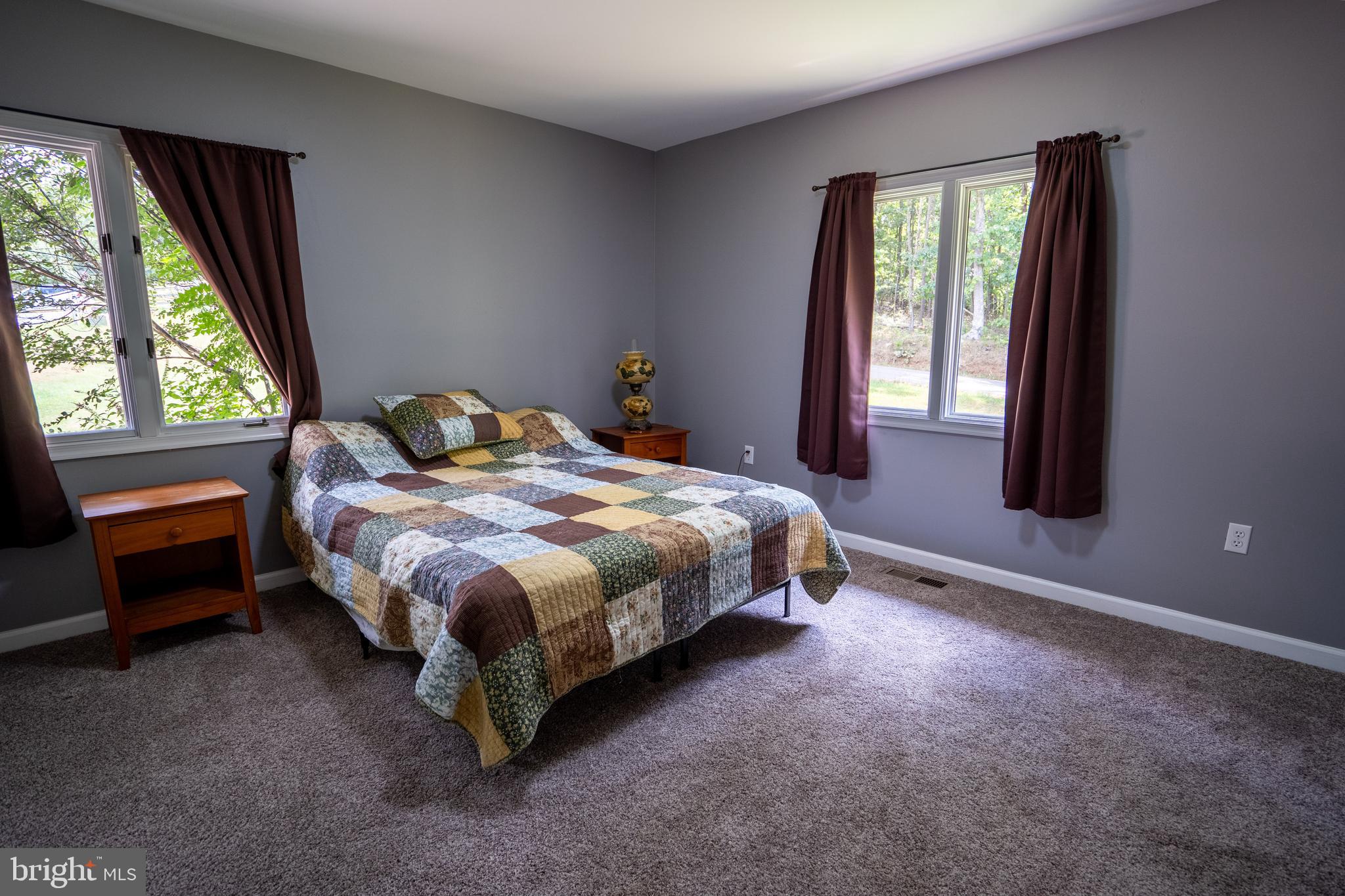 474 Potter Road Hedgesville, WV 25427 - Photo 22 of 40 a bed sitting in a bedroom next to a window