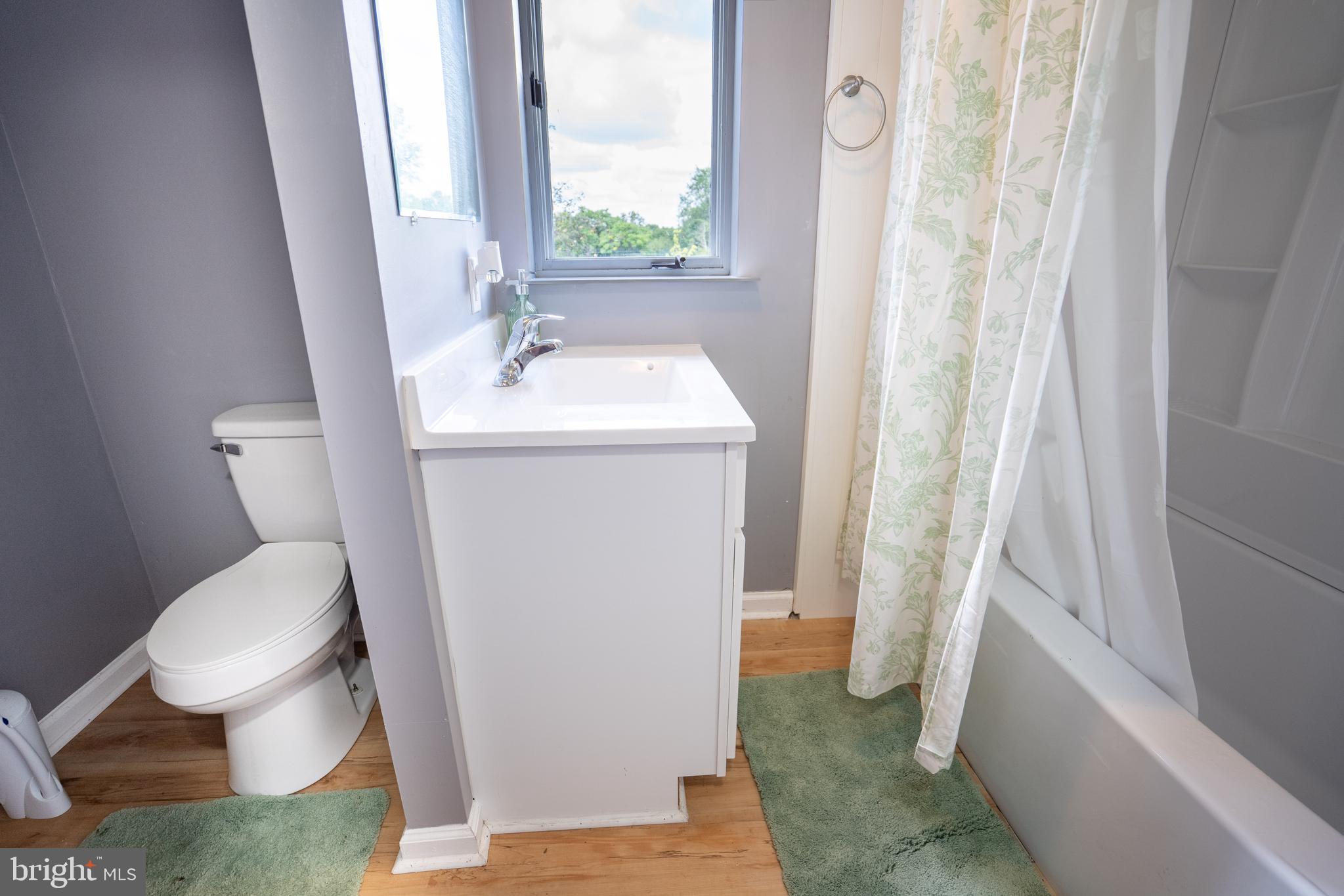 474 Potter Road Hedgesville, WV 25427 - Photo 25 of 40 a white toilet sitting next to a bathroom sink and tub