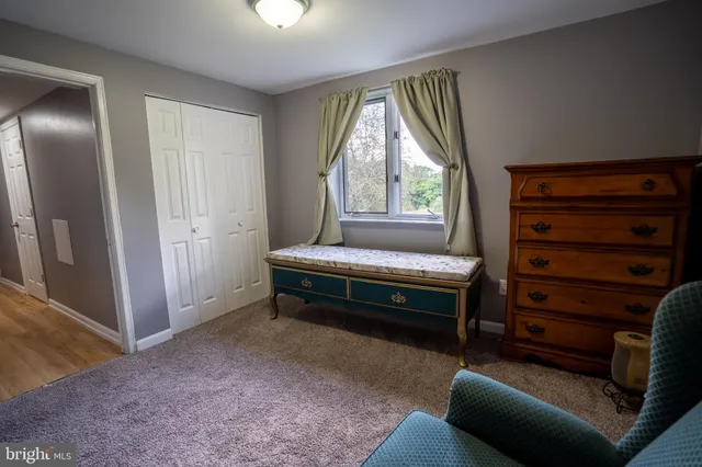 a bedroom with furniture and a window