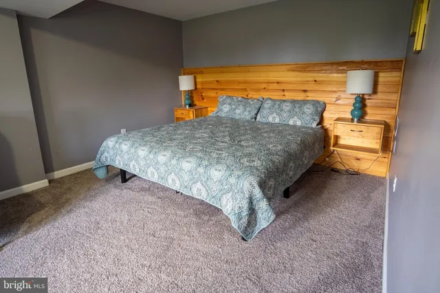 a bed sitting in a bedroom next to a window