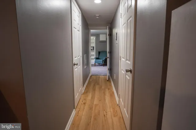 a view of a hallway with a livingroom and furniture