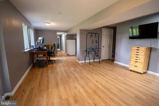 a view of a livingroom with furniture and a flat screen tv